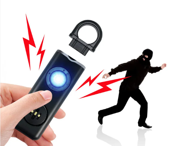 Hand holding a black pepper spray device with a blurred image of a person in a mask and red lightning bolts on a white background.