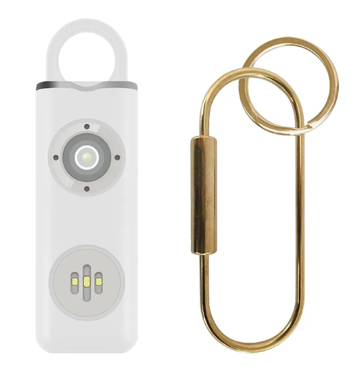 White electronic device with a gold keychain attachment on a white background